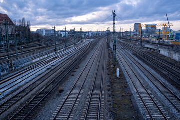 Fototapeta premium View of the railway tracks from the Donnersberger Bridge in Munich, Germany towards the west at dusk