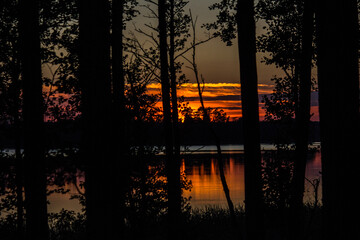 late sunset over the forest lake. Beautiful sunset 