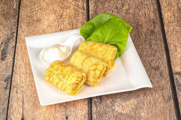 Stuffed pancakes with cream sauce