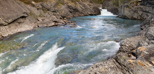 Naklejka na ściany i meble clear water of a stremo flowing between the rocks in Norway