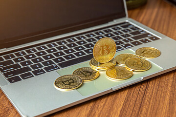 national flag of liberia on the keyboard with bitcoin coins on a grey background.concept