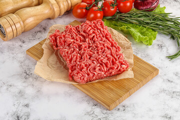 Raw minced beef meat on cutting board