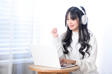Woman opens laptop, listens to music