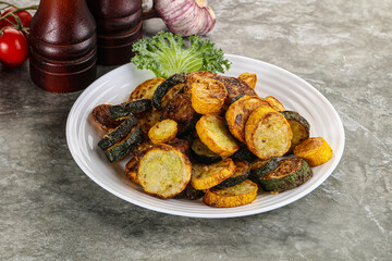 Roasted young zucchini in the plate