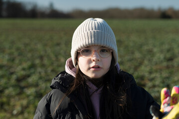 Portrait of a beautiful young girl in a field in winter.