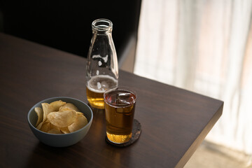 organic potato chips with soft drink on walnut table