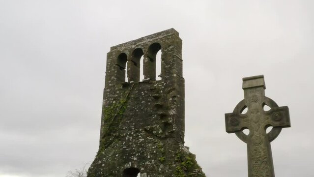 Revers pullback between graveyard Gaelic cross pattern on cemetery headstones