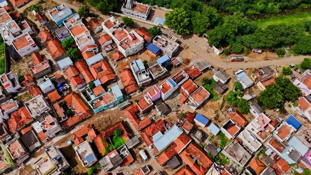 Top down shot of roofs of houses of Theni during sunny day in Tamil Nadu, India. Aerial shot.