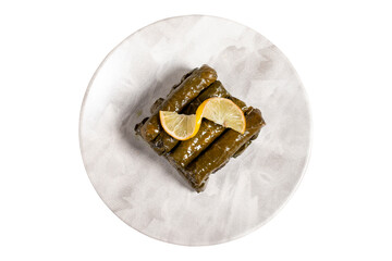 Stuffed grape leaves with olive oil. Turkish cuisine delicacies. Delicious stuffed grape leaves isolated on white background. Top view