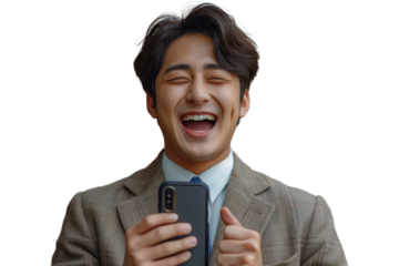 Happy asian young man in suit with phone rejoices in victory or winning isolated on transparent background