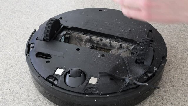 Cleaning robot vacuum cleaner. Hair tangled in a roller
