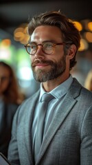 Obraz premium A bearded man with glasses wearing a suit stands thoughtfully in a room with soft lighting., generative ai