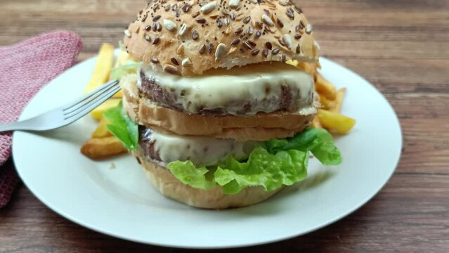 burger double et frites dans une assiette, en gros plan