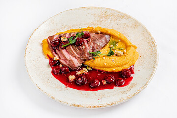 duck with pumpkin puree and cranberry sauce