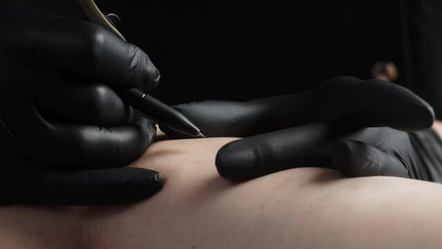 The process of removing unwanted hair using a device for electrolysis in a cosmetology office on a dark background. Close-up macro photography.