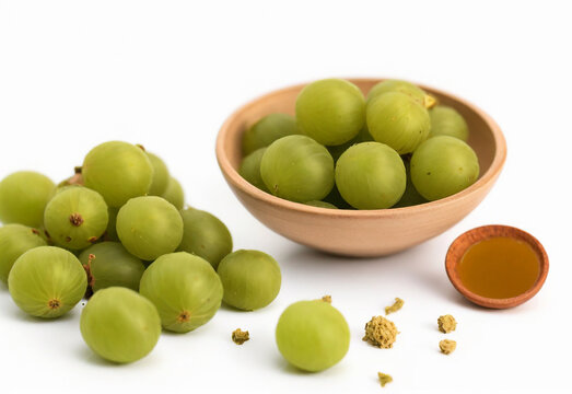 Amla powder with raw avla on white background