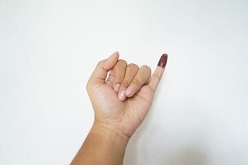Little finger smeared with ink as proof of having voted in the elections in Indonesia or known as Pemilu