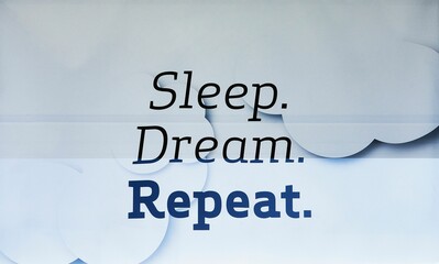 Writing on a bedding store window stating 'Sleep, Dream, Repeat'