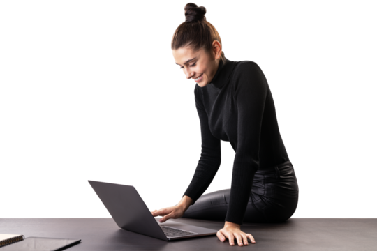 Businesswoman working on laptop at desk, professional office environment