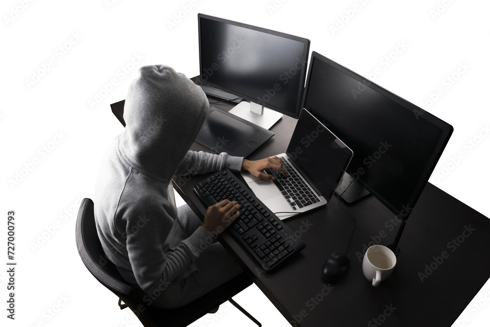 Aufkleber Silhouetted hacker at a desk with multiple computers, cybersecurity concept