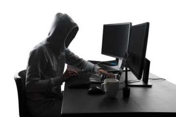 Anonymous figure in hoodie at computer workstation, cybersecurity and anonymity concept