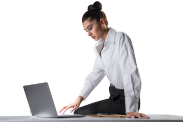 Engrossed businesswoman working on laptop, kneeling on desk for better focus
