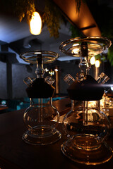 Obraz premium Hookah flasks. Hookah smoking. The flasks are on the bar counter in the lounge bar. Hookah room.