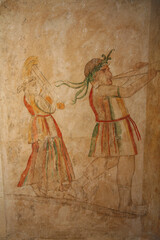 Beit Guvrin Maresha National Park. Sidonian burial caves with wall paintings. The musicians' grave is decorated with a painting depicting a man playing a flute and a woman playing a harp. Israel - 727006189