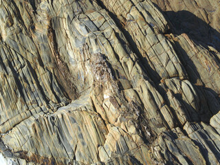 Colorful slate natural rocks at the beach of Vila Nova de Milfontes in Portugal