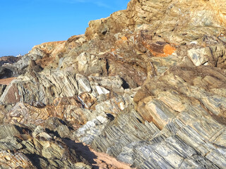 Colorful slate natural rocks at the beach of Vila Nova de Milfontes in Portugal