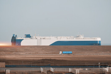 International Trade Shipping Logistics And Supply Chain In The Port. Pure Car Carrier And Container Cargo Truck In Motion © I am from Mykolayiv