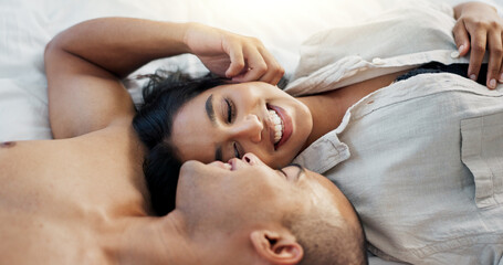 Happy couple, bed and talking of love, intimacy and romance at home for relationship and bonding....