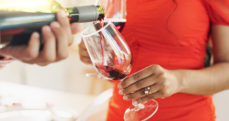 Couple, hands and bottle of red wine for celebration of love, romance and valentines day on their...