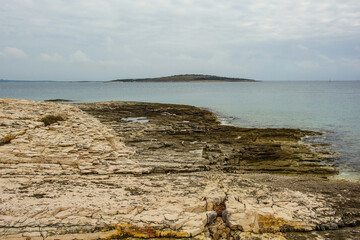 The rugged limestone landscape of the Kamenjak National Park on the Premantura peninsula in Medulin...