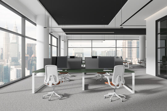 Coworking interior with desk and pc desktop with armchairs, panoramic window