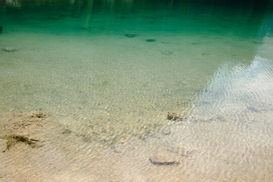 Tranquil Lake with Crystal Clear Water and Sandy Bottom, Surrounded by Natures Beauty