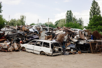 Scrapyard with a pile of old rusty cars and scrap metal ready to be recycled - obrazy, fototapety, plakaty