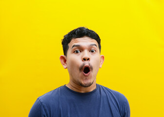 Portrait of the face of an Asian young man with a shocked expression. Studio shoot