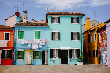 Colorful houses with laundry hanging from the windows in Burano, Italy