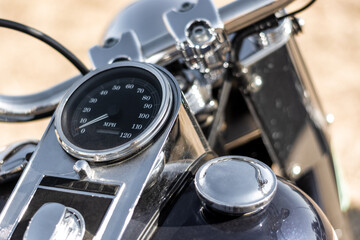 Close up of the engine of a vintage motorcycle with a speedometer