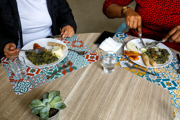 Migrants eating a meal they cooked as apprentices at la Maison Bakhita, Paris.