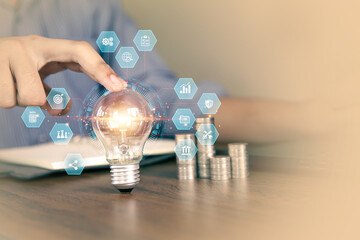 Hand choose light bulb with bright light and business plan icons for creative idea innovation of technology in analyzing global marketing online data management services to target growth concept.