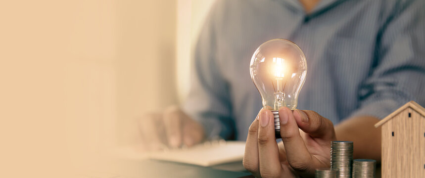 Hand choose light bulb with bright light for creative idea innovation of technology in analyzing global marketing online business plan data management services to target growth concept.