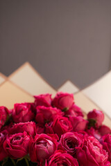 Beautiful bouquet of pink roses on a gray background. Congratulatory bouquet of roses for Mother's Day.