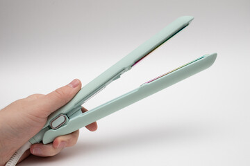 hair straightener with ceramic plates on hand