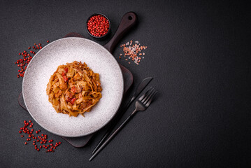 Delicious asian udon dish with vegetables, mushrooms, salt and spices