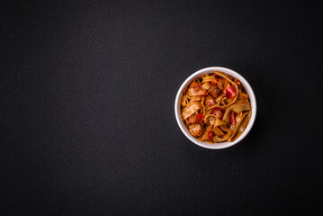 Delicious asian udon dish with vegetables, mushrooms, salt and spices