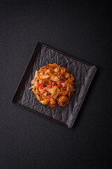 Delicious asian udon dish with vegetables, mushrooms, salt and spices