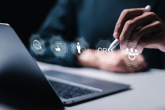 ORM, Online reputation management optimization business concept, Person using laptop with virtual screen of ORM icon for online reputation management.