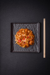 Delicious asian udon dish with vegetables, mushrooms, salt and spices
